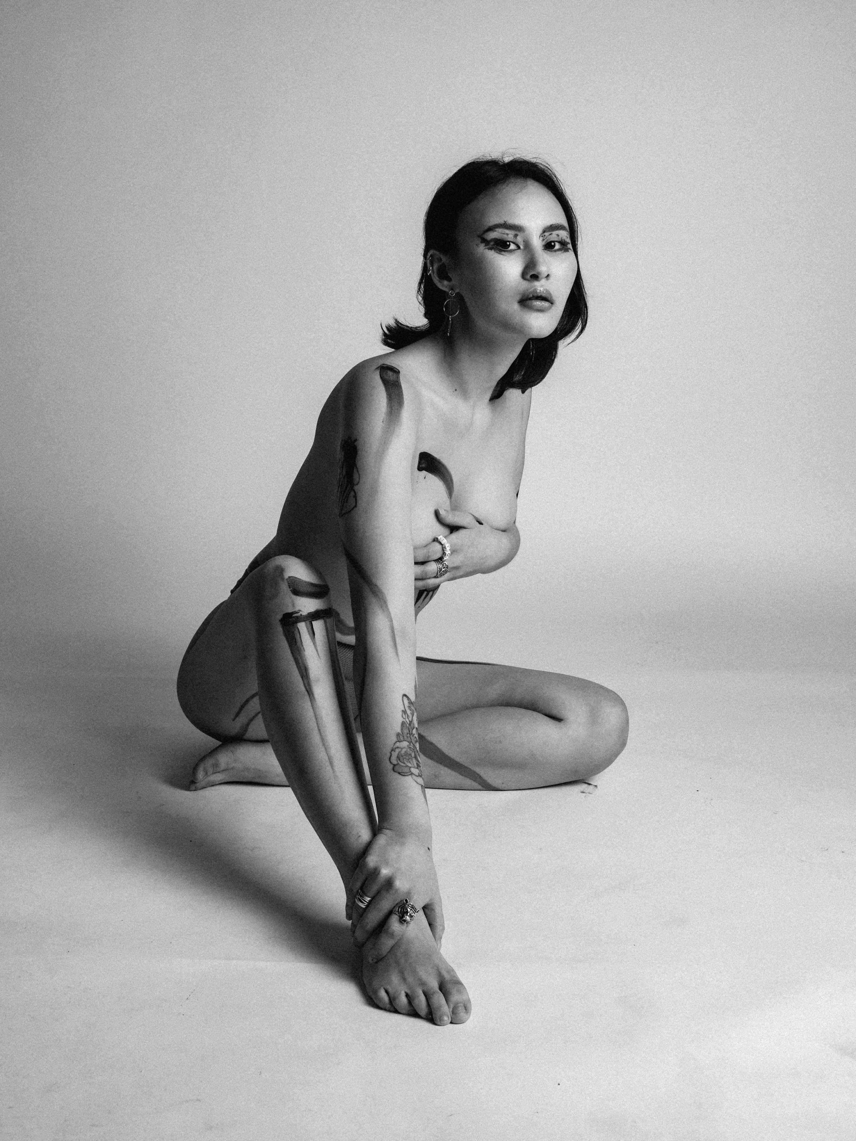 black and white portrait of naked woman in body paint