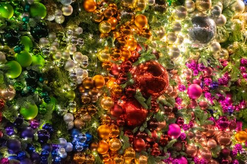 Free A colorful array of Christmas baubles and lights creating a festive atmosphere. Stock Photo