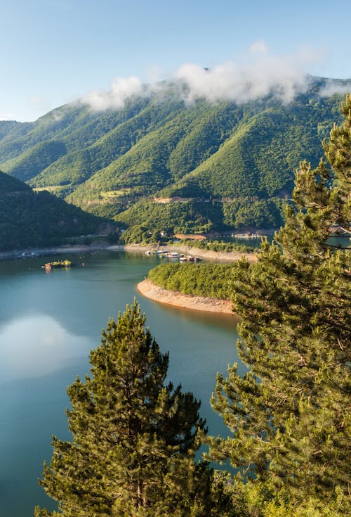 Beautiful Landscape of Green Mountains and a Lake Under Blue Sky 