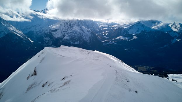 Breathtaking aerial view of snowy mountains in Hasliberg, Switzerland.