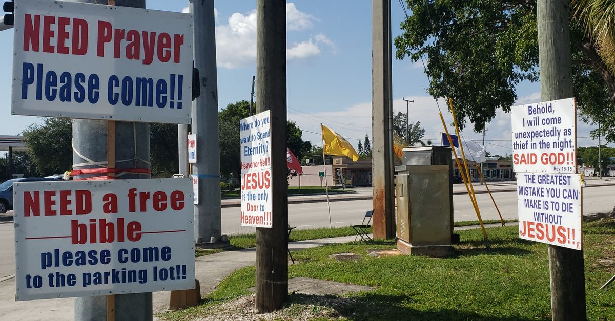 Outdoor religious signs inviting prayer and free bibles in West Palm Beach, Florida.