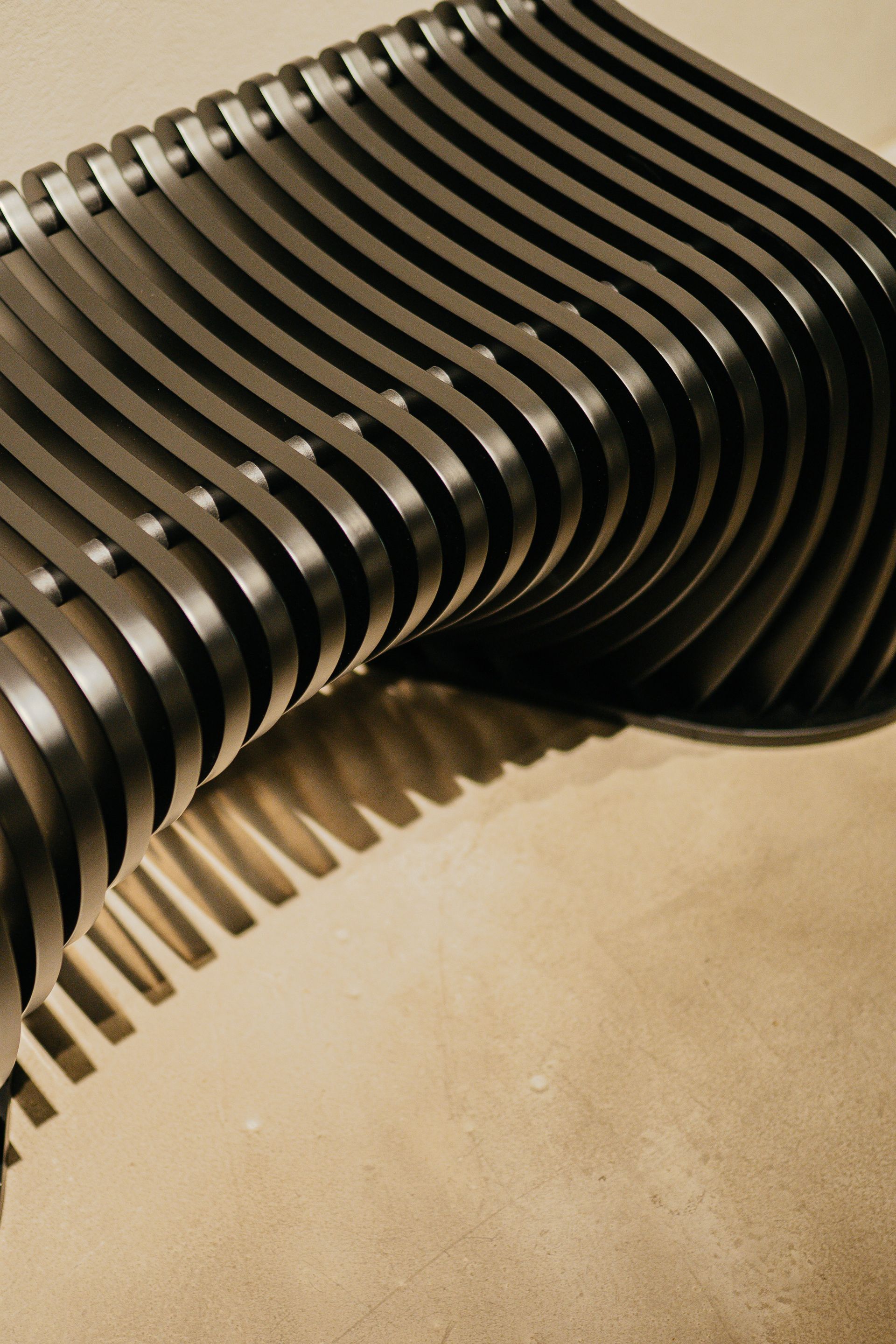 A close-up of a contemporary metal structure casting intriguing shadows