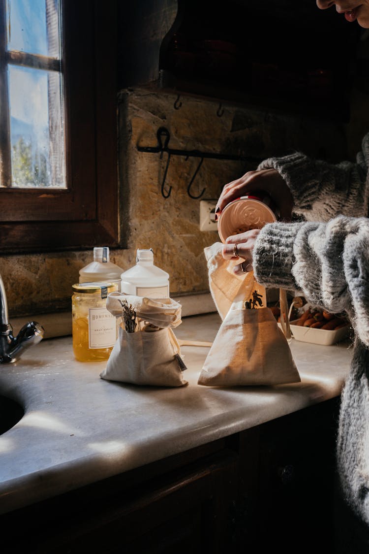 Hands Of A Person Holding A Container And A Bag