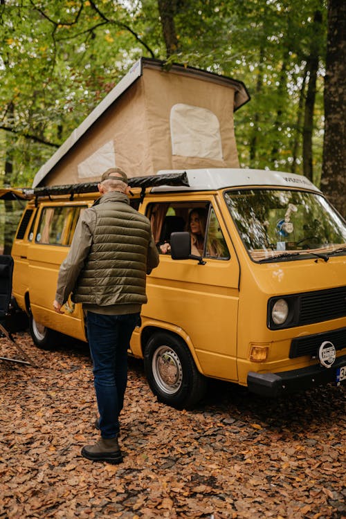 Free Man Standing by Van in Forest Stock Photo