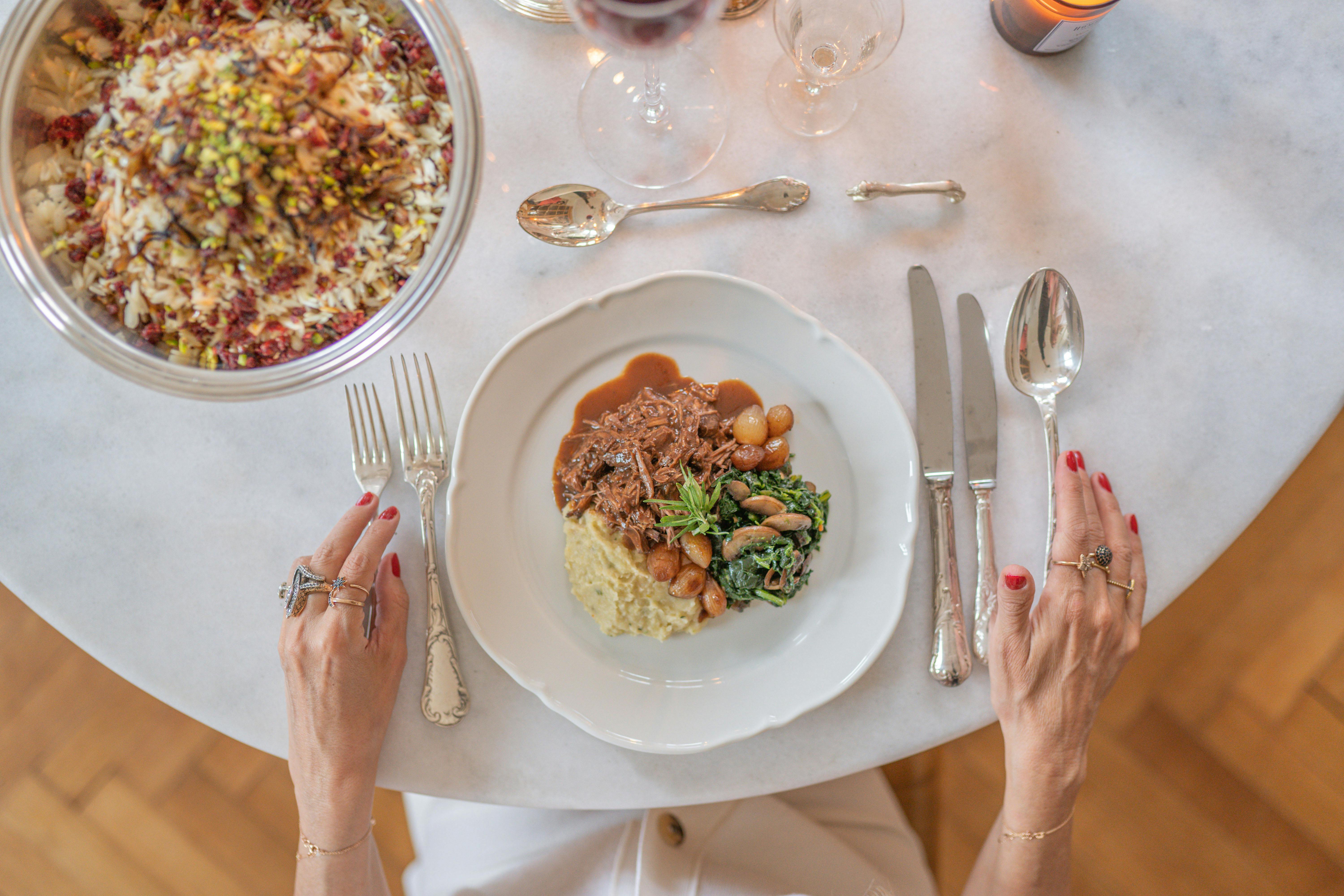 woman sitting at table ready to eat dinner