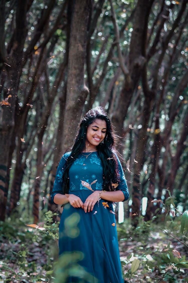 Happy Indian Woman In Dress In Forest