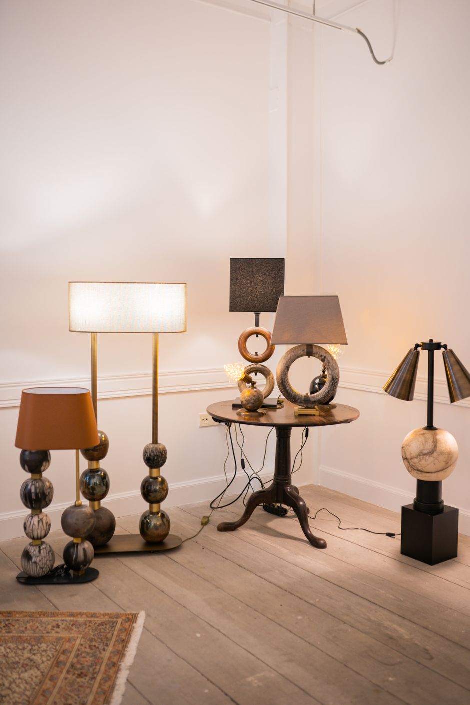 A variety of stylish indoor lamps in a modern minimalist interior setting.