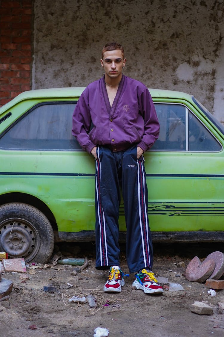 A Man Standing By A Car