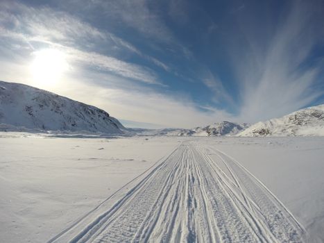 Capture of a pristine snowy landscape under a bright winter sky in Kangiqsualujjuaq, Quebec, Canada.