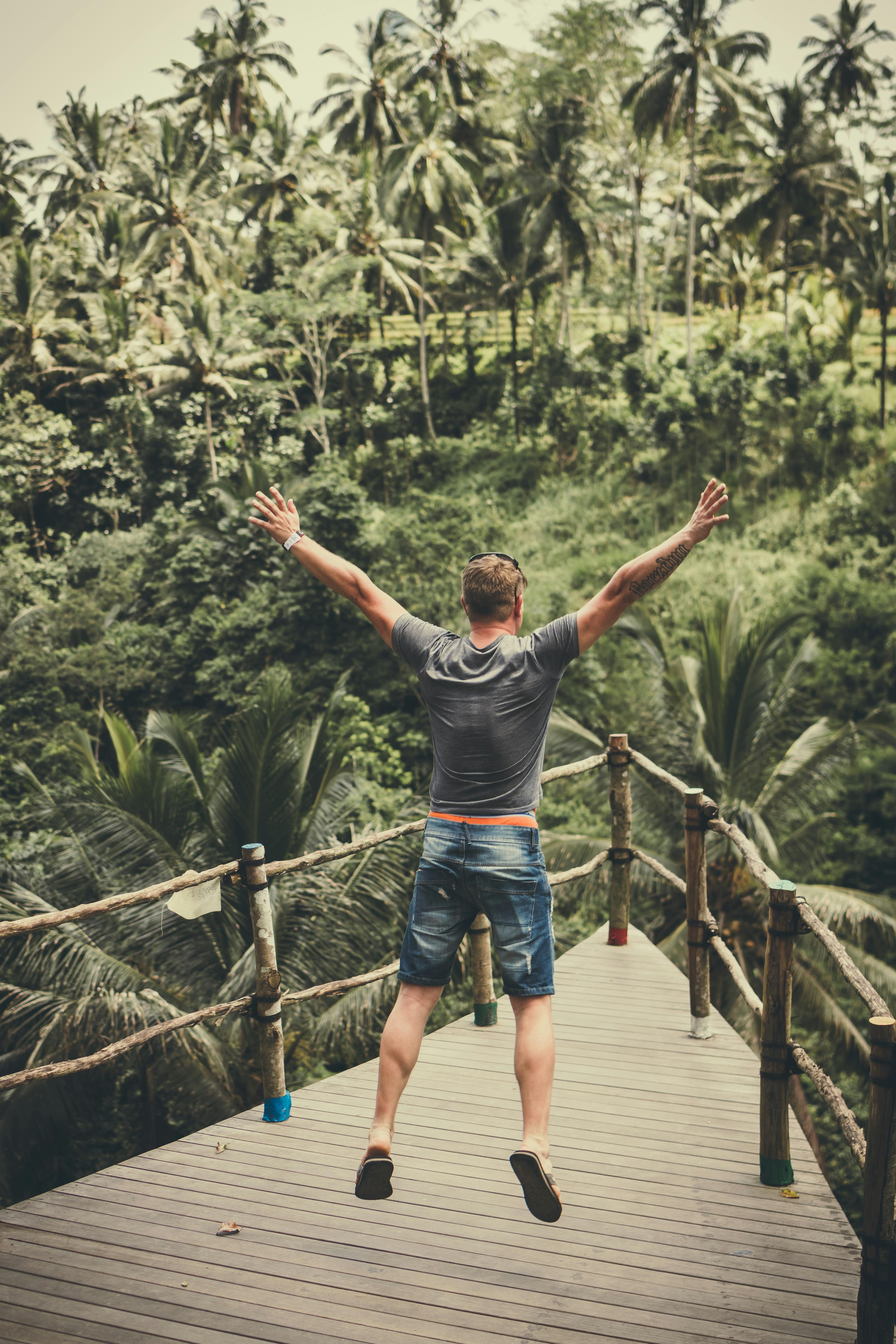 man jumping on wooden balcony