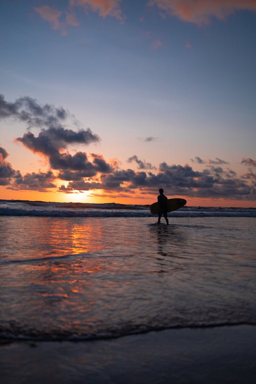 Silhouette of a Surfer at the Beach