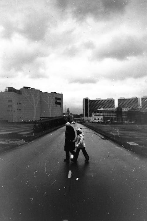 Two People Crossing a Street