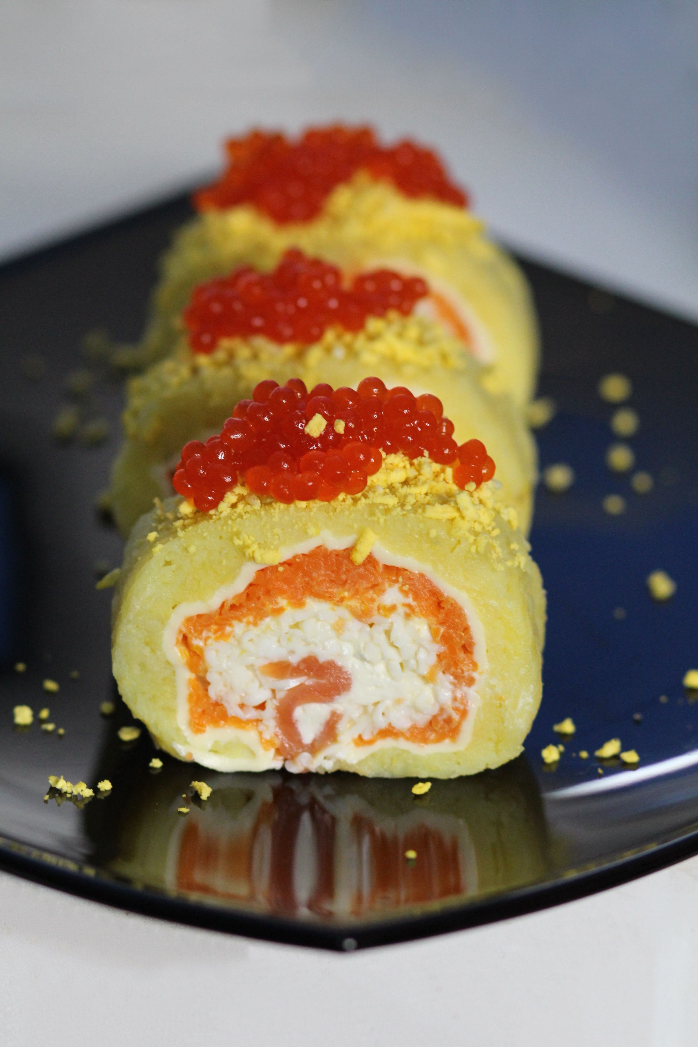 Delicious gourmet sushi roll topped with caviar and filled with salmon and cream cheese.
