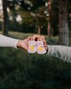 Person Holding Heart Shaped White and Brown Ornament