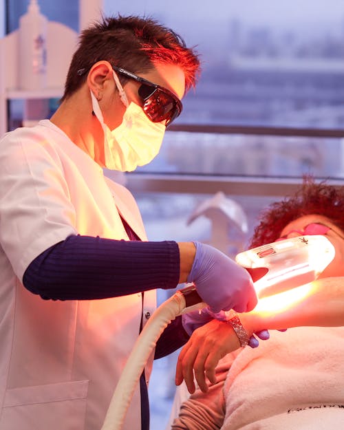 Free Woman Giving Laser Treatment Stock Photo