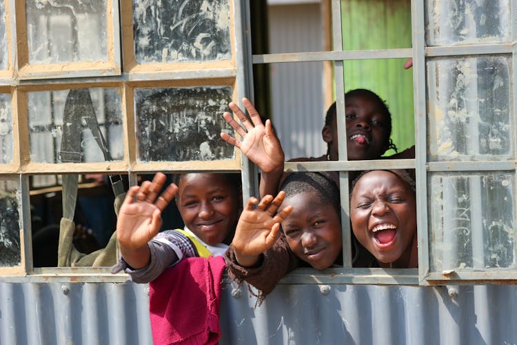 A Children Looking On The Window