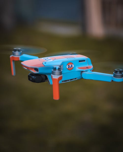 Blue and Orange Drone Flying