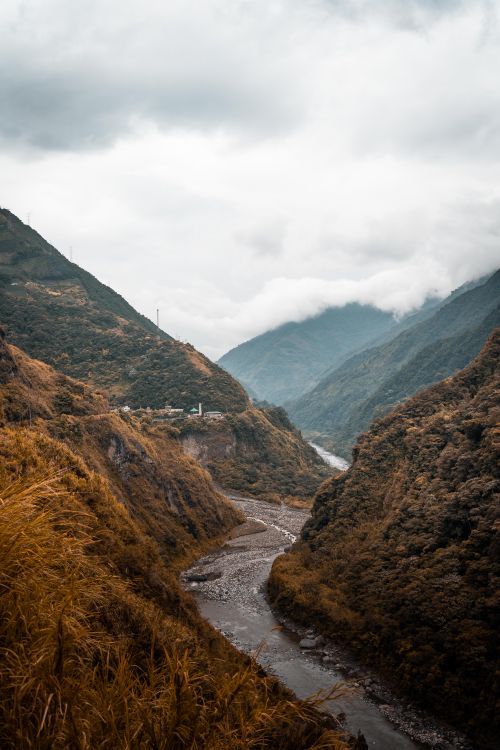 Free Majestic view of a river valley amid lush green mountains and clouds in Ecuador. Stock Photo