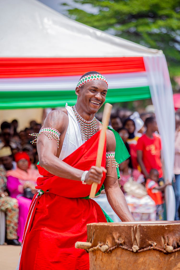 Man Playing A Drum For A Crowd