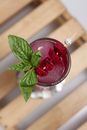 Clear Drinking Glass With Red Liquid and Green Leaves
