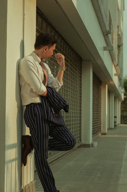 Elegant Man Leaning Against a Wall 