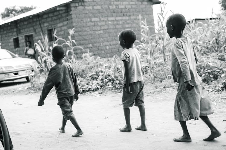 Kids Walking Barefoot On Street