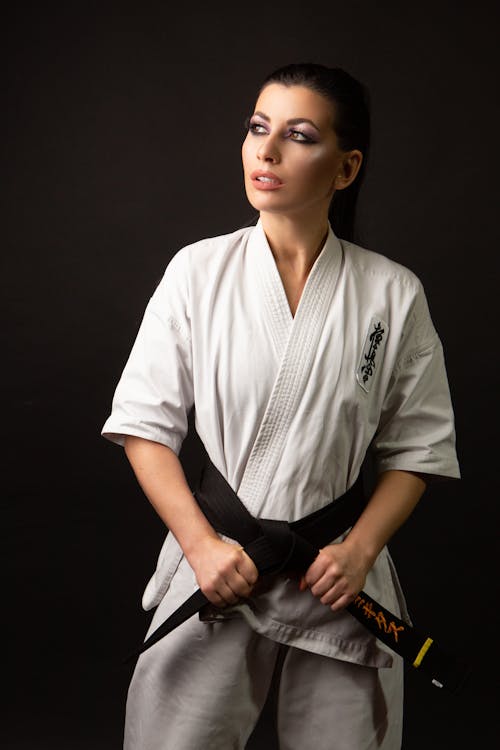 Woman in White Karate Uniform Clenching Fists