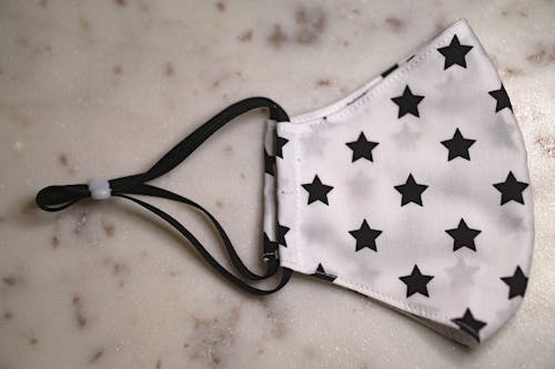A Face Mask With Stars Print Fabric