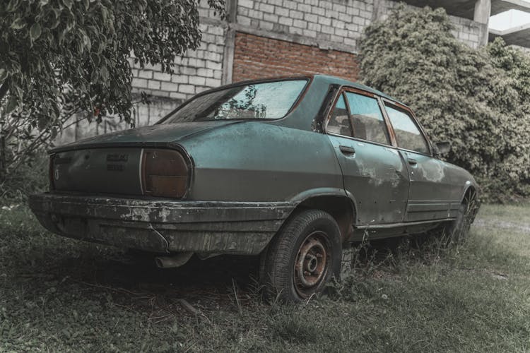 Old Car Parked On Green Grass Field