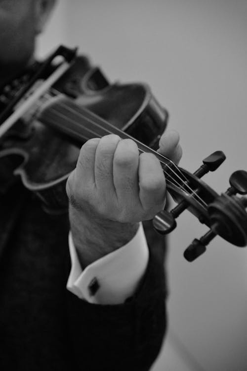 Close-up View of Person Playing on Violin