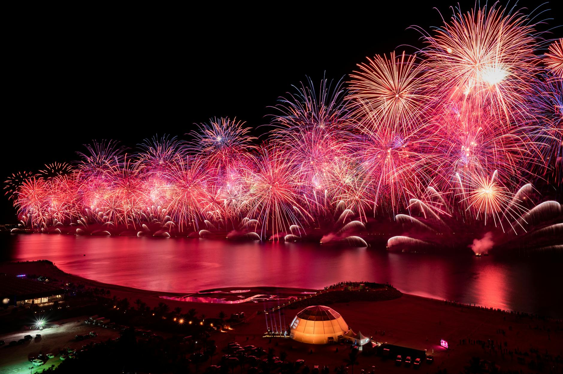 Spectacular fireworks display over the water in Ras Al-Khaimah, creating a vibrant celebration ambiance.