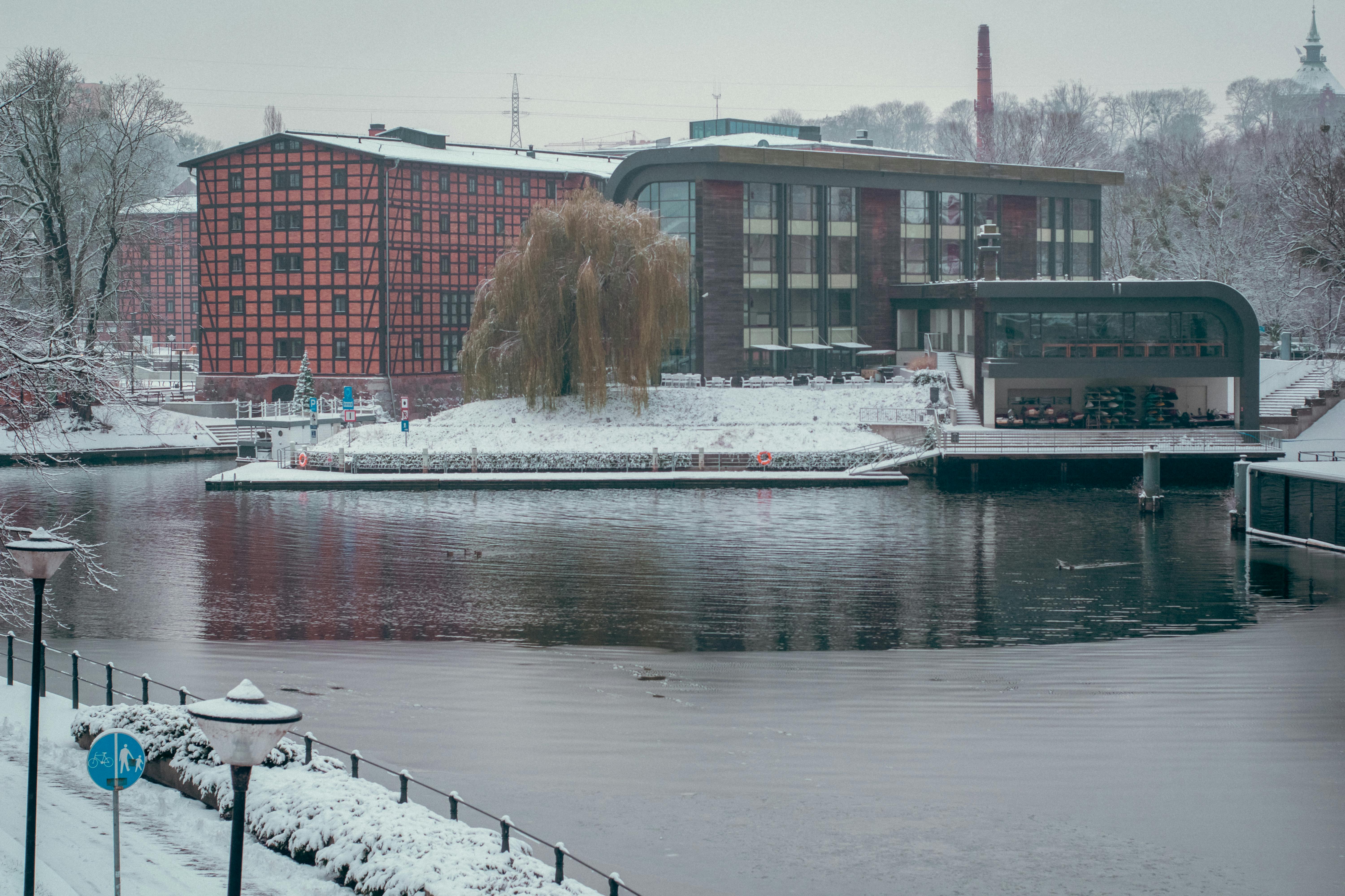 white boat on water near brown concrete building