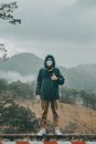 Woman in Black Jacket Standing on Brown Field