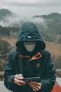 Man in Black and Orange Jacket and Black Knit Cap