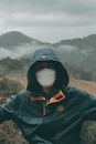 Person in Blue and Orange Jacket Wearing Black Goggles