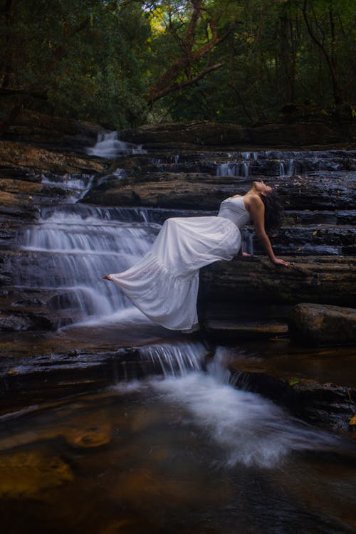 Woman Posing against Waterfall