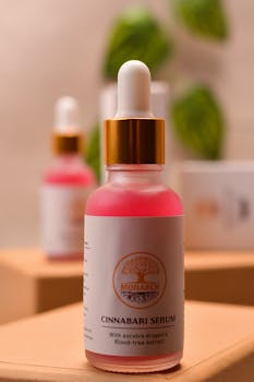 Close-up of a Cinnabari serum bottle with Socotra dragon's blood-tree extract on wooden surface.