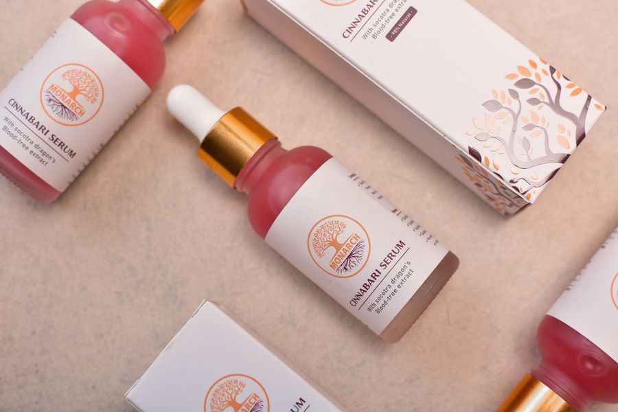 Serum bottles on beige backdrop