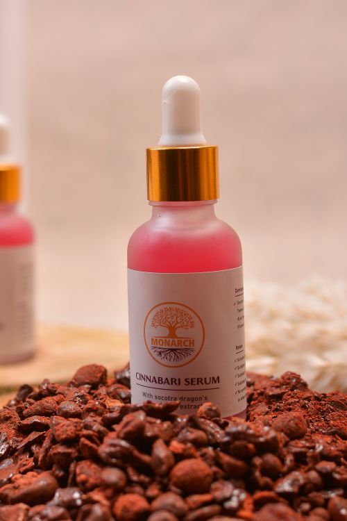Free Close-up of Cinnabari Serum bottle surrounded by raw cinnabar stones for skincare. Stock Photo