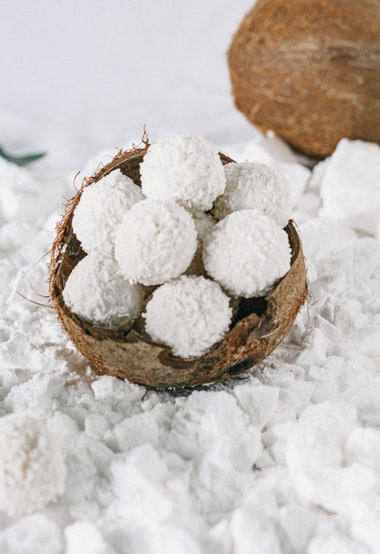 White Balls With Grated Coconut On A Wooden Bowl