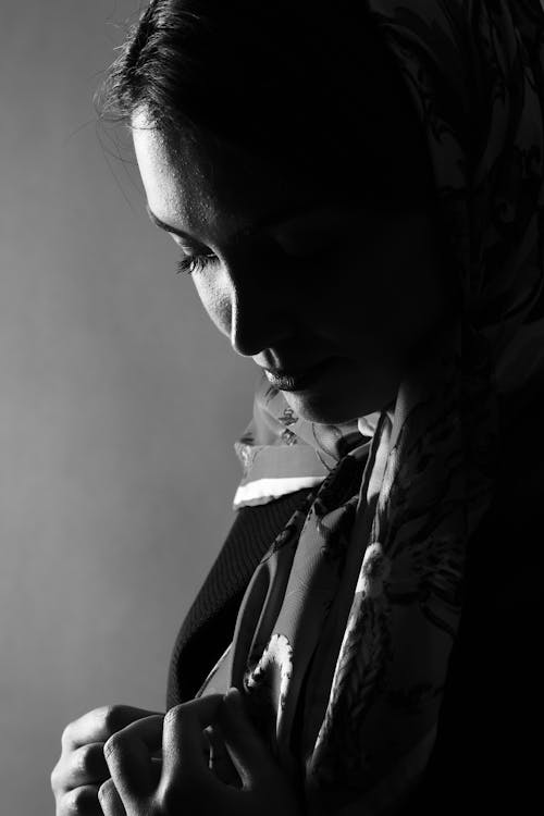 Grayscale Photo of a Woman Wearing a Scarf