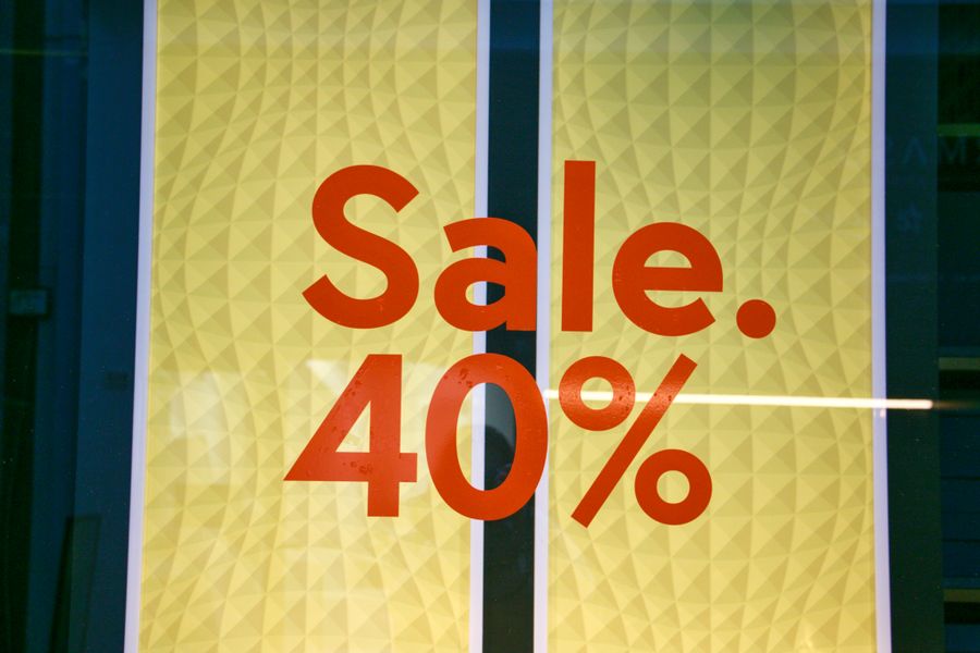 Shop window poster reading Sale 40% in red on yellow