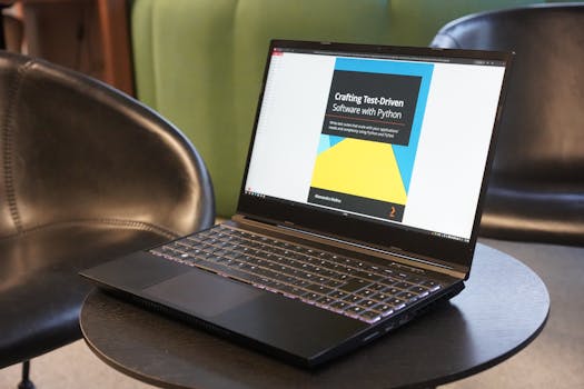 A close-up of a laptop on a table, displaying a book on test-driven software with Python, set in a comfortable environment.