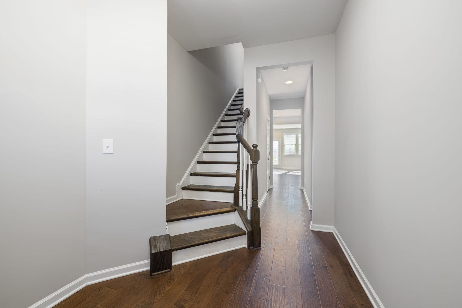 Dark timber flooring with matching stair and hallway detailing