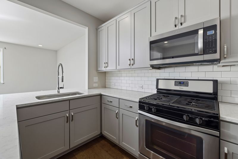 Sleek modern kitchen featuring stainless steel appliances and white cabinetry