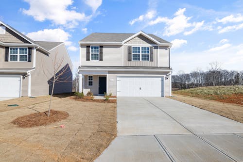 White and Gray Wooden House with Driveway