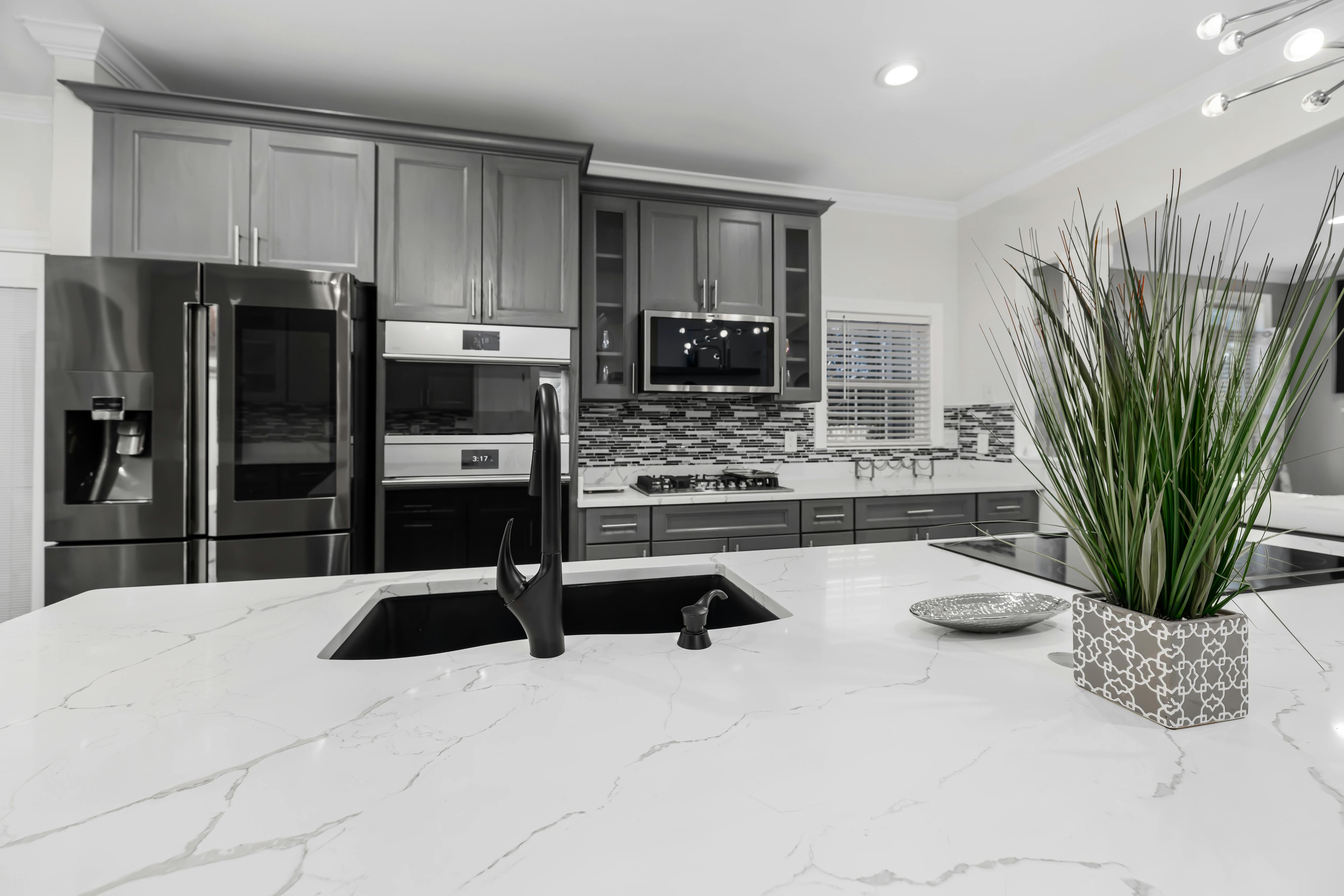 Sleek modern kitchen featuring marble countertops and elegant cabinetry.