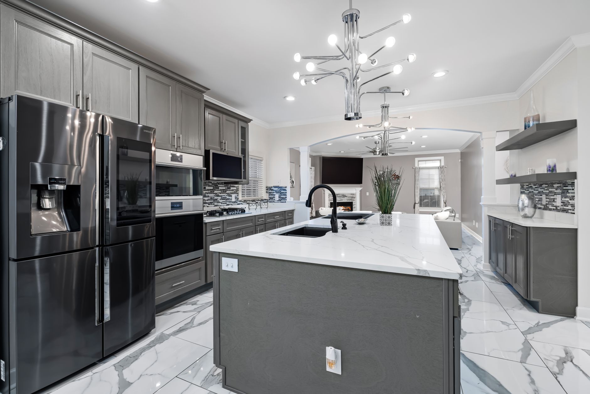 quiet luxury kitchen transformation for modern homes Sleek modern kitchen design featuring stainless steel appliances, marble countertops, and elegant lighting.