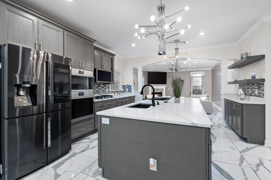 A modern kitchen island with quartz countertops and sleek bar seating - modern 1 bedroom apartments A modern kitchen island with quartz countertops and sleek bar seating - modern 1 bedroom apartments