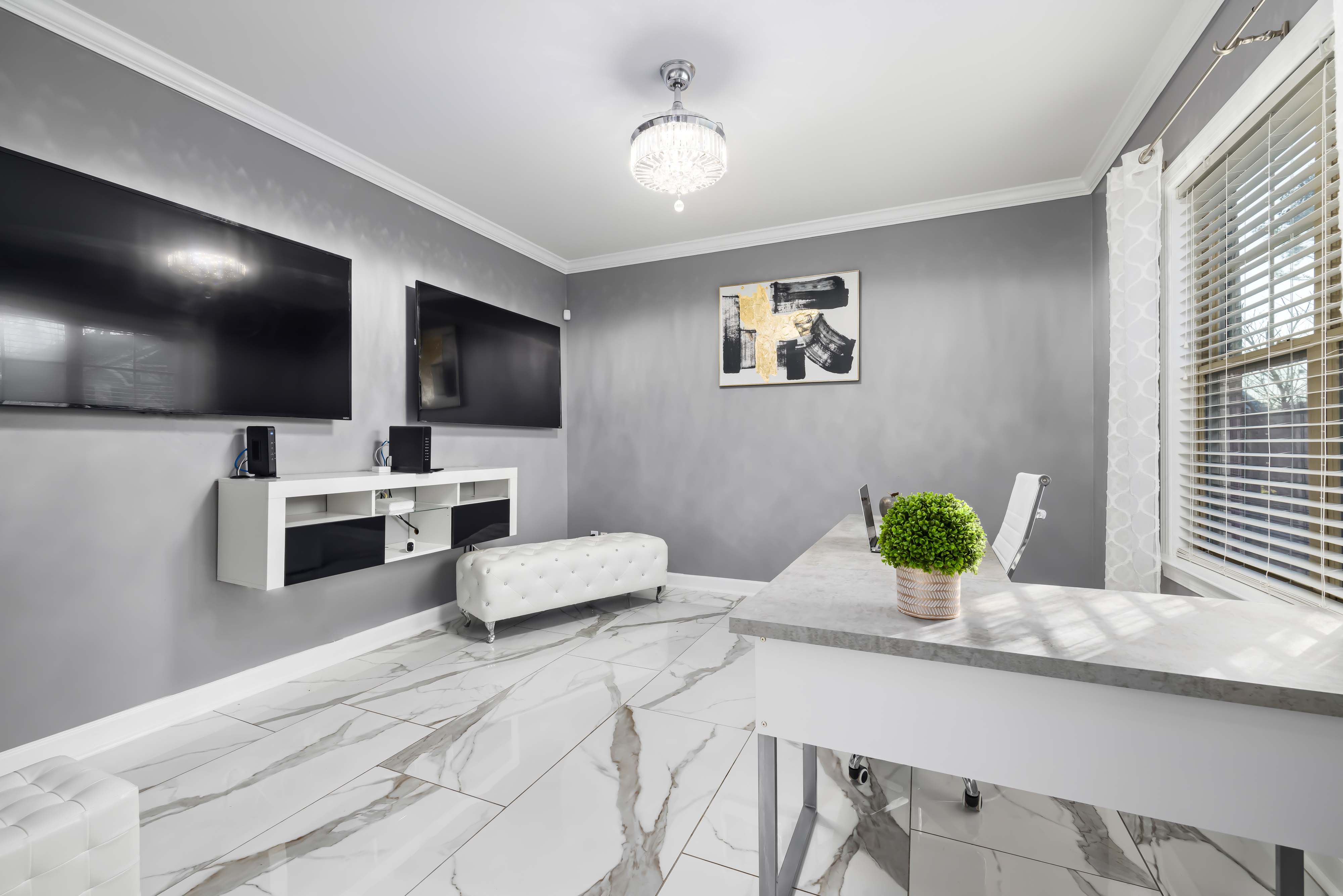 Modern home office space with minimalist TV stand and sleek desk